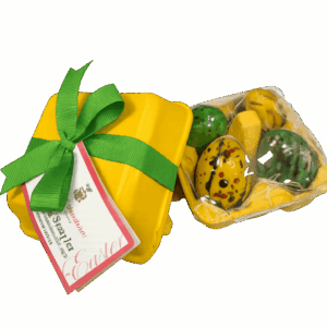 Yellow Easter chocolate egg sampler in molded pulp egg carton with green ribbon and speckled chocolates