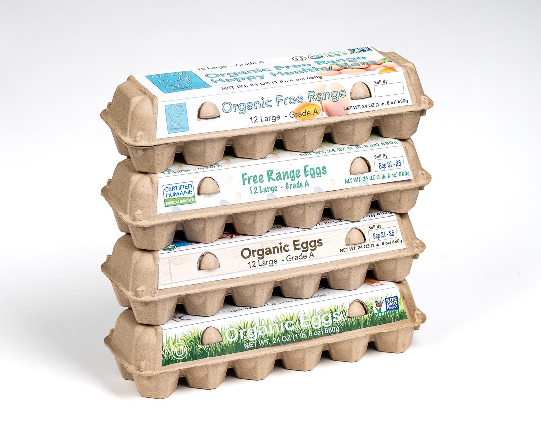 Stacked Natural closed-top 12-egg chicken egg cartons made from molded paper pulp